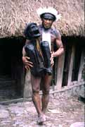 Villager from Dani tribe with 300 years old mummy. Jiwika village. Papua, Indonesia.